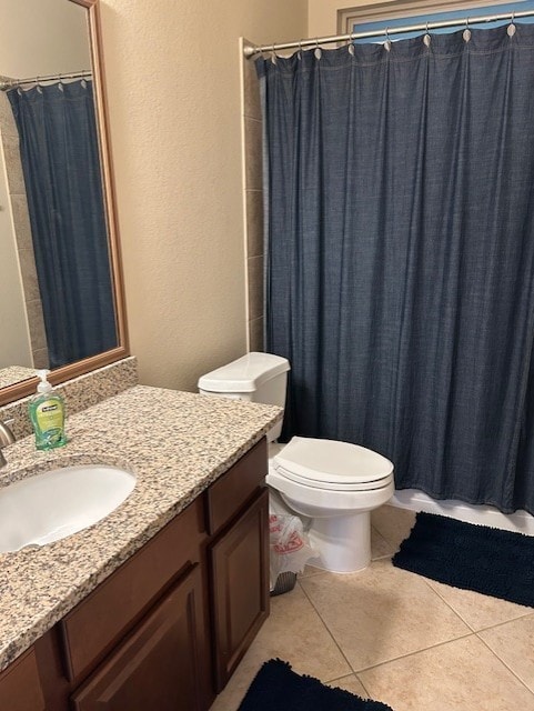 bathroom featuring tile patterned flooring, vanity, and toilet