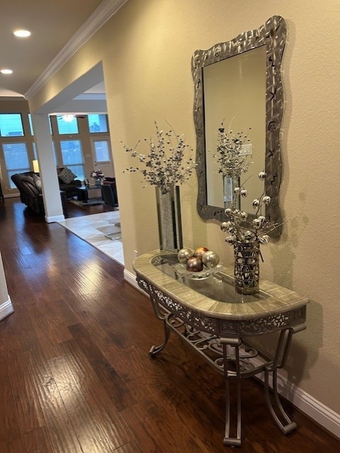 corridor featuring ornamental molding and hardwood / wood-style flooring