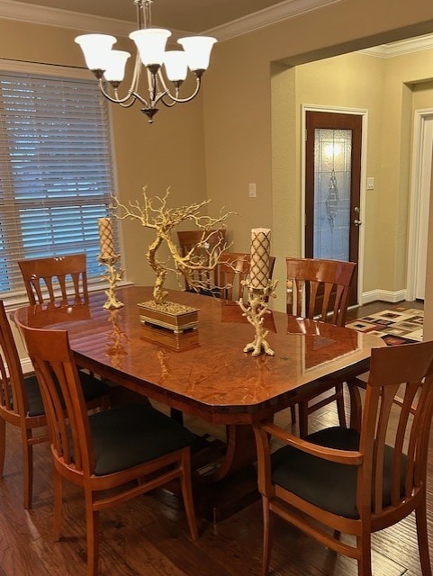 dining area featuring an inviting chandelier, crown molding, and wood-type flooring