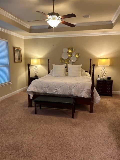 carpeted bedroom with ceiling fan, a raised ceiling, and crown molding