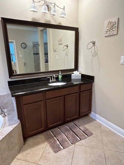 bathroom with vanity, tile patterned floors, and tiled tub