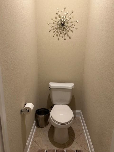 bathroom with toilet and tile patterned flooring