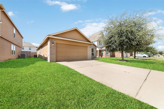 view of front of house featuring central air condition unit, a front yard, and a garage