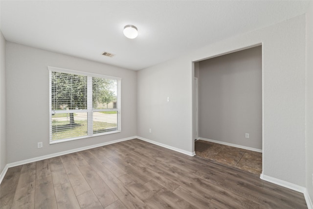 empty room featuring dark hardwood / wood-style floors