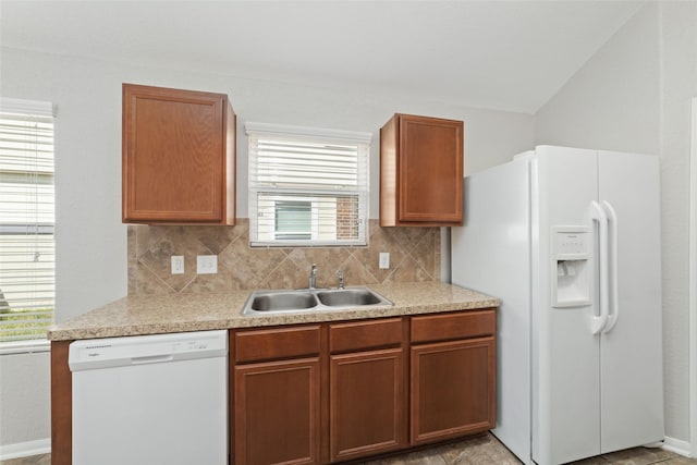 kitchen featuring sink, white appliances, a healthy amount of sunlight, and backsplash