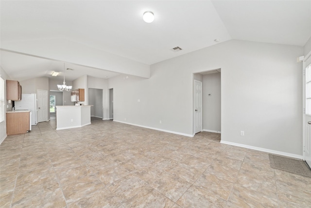 unfurnished living room featuring lofted ceiling and a notable chandelier