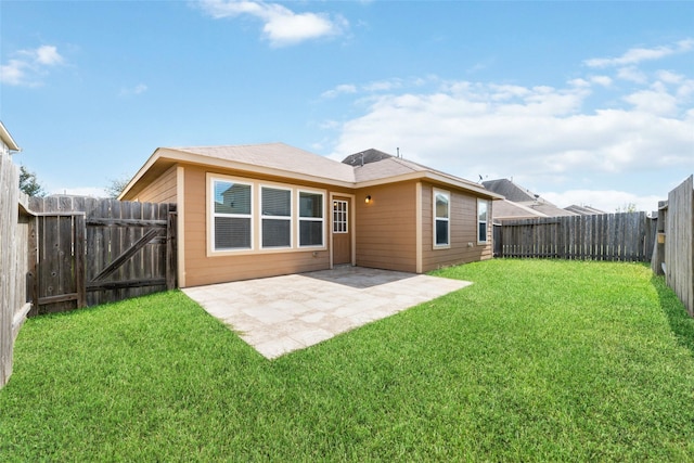 back of property with a patio area and a lawn