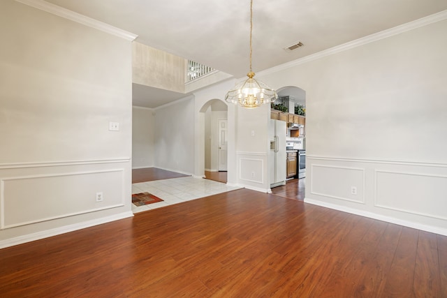 unfurnished dining area with crown molding, light hardwood / wood-style floors, and a notable chandelier