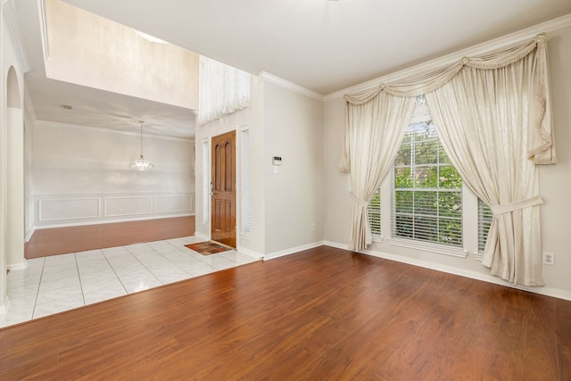 interior space featuring crown molding and light hardwood / wood-style flooring