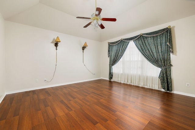 spare room featuring ceiling fan, vaulted ceiling, and wood-type flooring