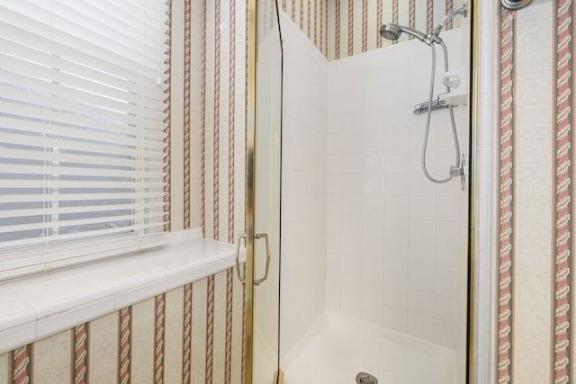 bathroom with a shower with shower door