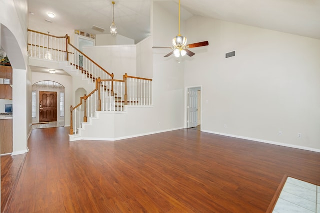 unfurnished living room with high vaulted ceiling, ceiling fan, and dark hardwood / wood-style flooring