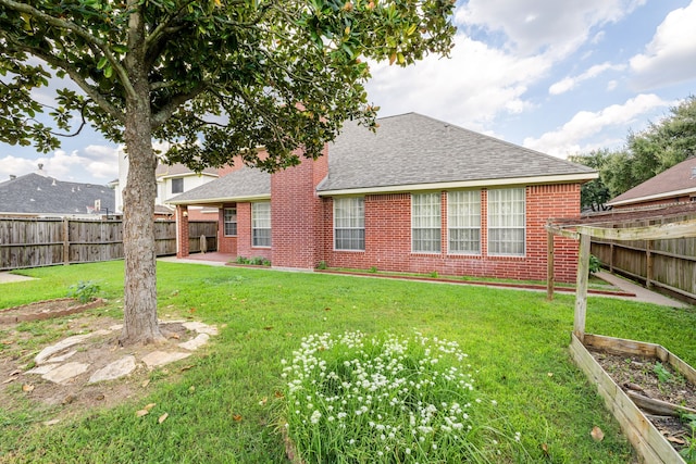 back of house with a lawn