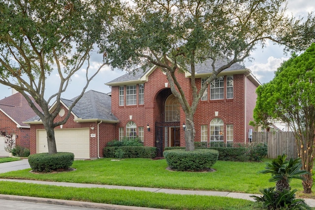 view of front of home featuring a front yard and a garage