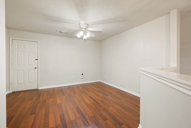 spare room with ceiling fan and dark hardwood / wood-style flooring