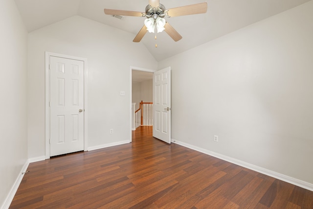 unfurnished bedroom with lofted ceiling, ceiling fan, and dark wood-type flooring