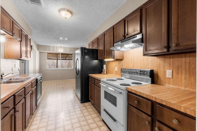 kitchen featuring a textured ceiling, sink, butcher block counters, black appliances, and dark brown cabinetry