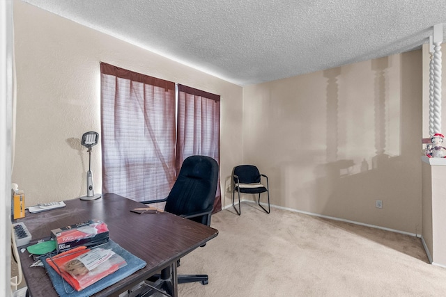 office area featuring a textured ceiling and light carpet