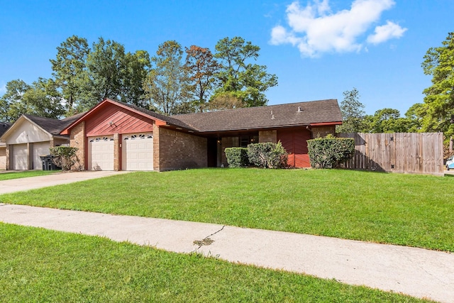 ranch-style house featuring a front yard and a garage