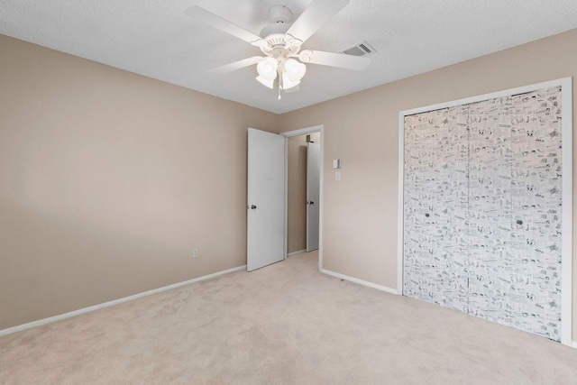 unfurnished bedroom with a closet, ceiling fan, and light carpet