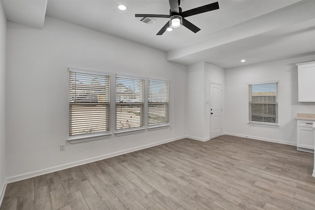 spare room featuring light hardwood / wood-style floors and ceiling fan