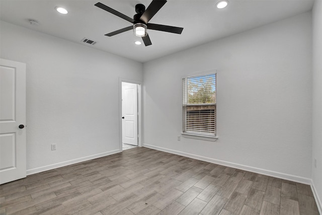 unfurnished room with ceiling fan and light hardwood / wood-style flooring