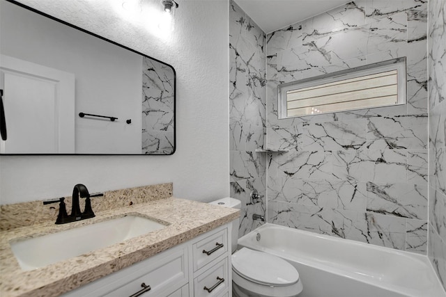 full bathroom featuring toilet, vanity, and tiled shower / bath