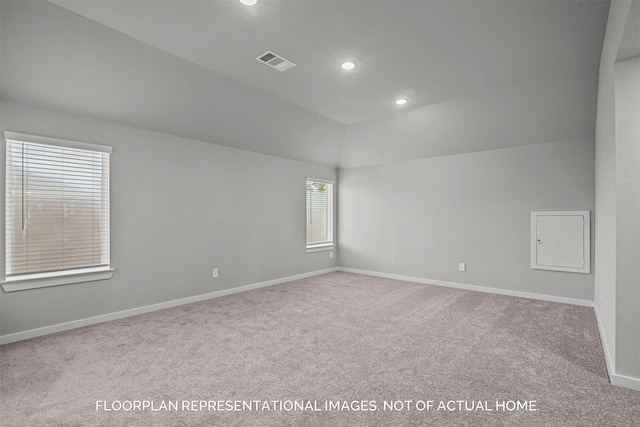 carpeted spare room featuring baseboards, visible vents, vaulted ceiling, and recessed lighting