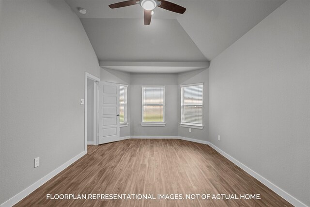 spare room with lofted ceiling, hardwood / wood-style flooring, and ceiling fan