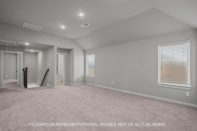 interior space featuring light carpet and lofted ceiling