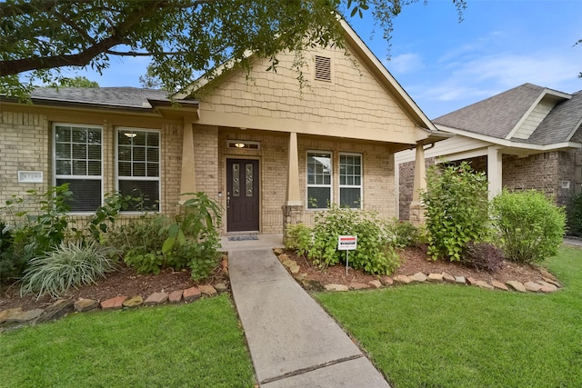 craftsman-style house with a front yard and a porch