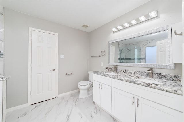 bathroom with vanity, a shower with shower door, and toilet