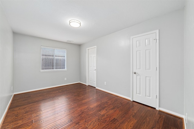 spare room featuring dark hardwood / wood-style flooring