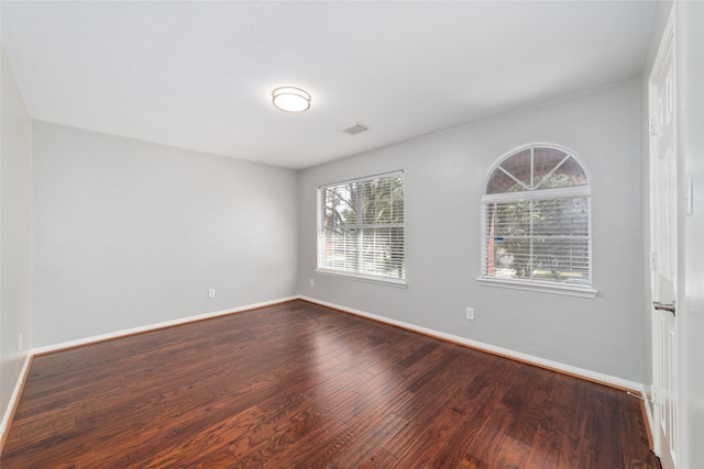 empty room with wood-type flooring and a wealth of natural light