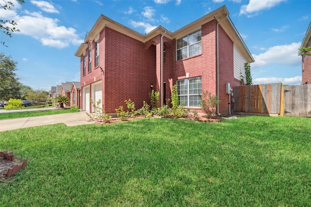 view of front of home featuring a garage and a front lawn