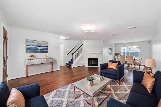 living room with a fireplace and dark hardwood / wood-style floors