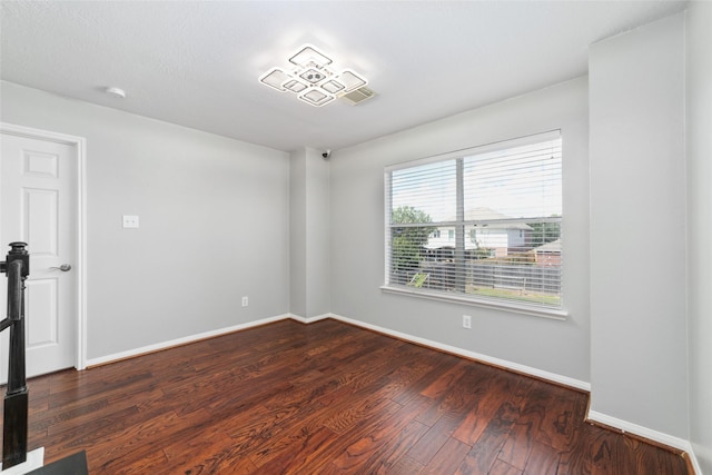 spare room featuring dark wood-type flooring