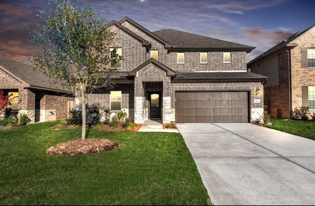 view of front facade with a lawn and a garage