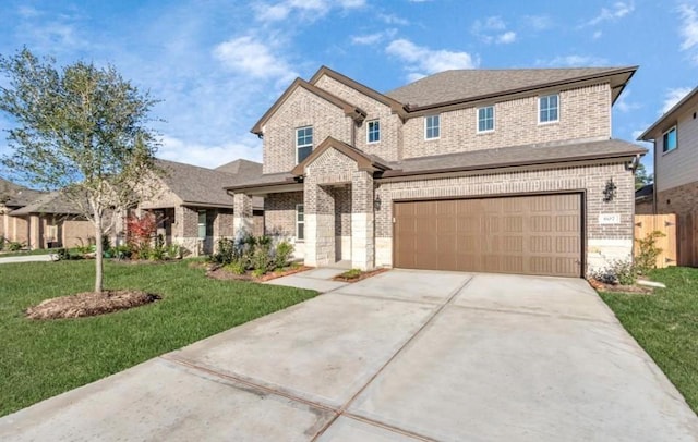 view of front of property featuring a front lawn and a garage