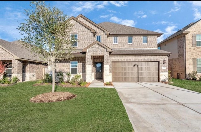 view of front of property featuring a garage and a front lawn