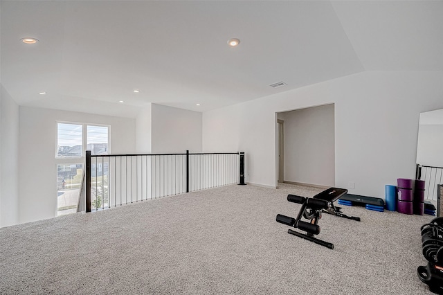 workout room with vaulted ceiling and carpet flooring