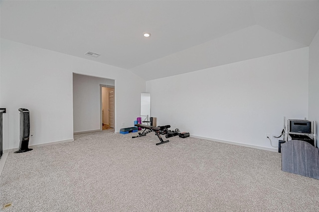 exercise area featuring light carpet and lofted ceiling