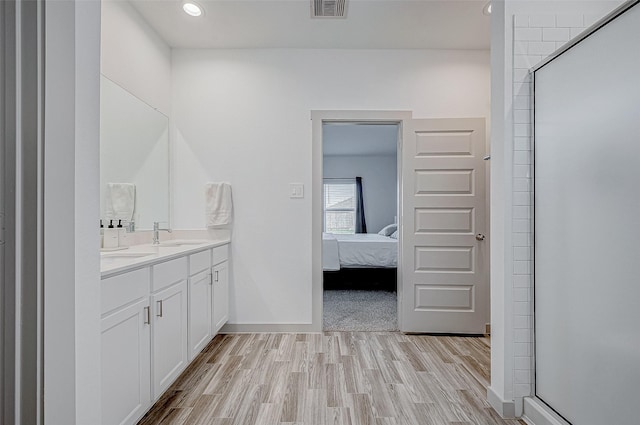 bathroom featuring vanity, walk in shower, and hardwood / wood-style flooring