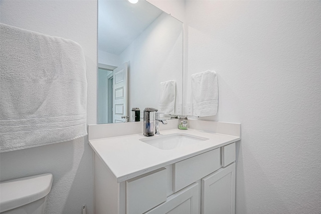 bathroom featuring toilet and vanity