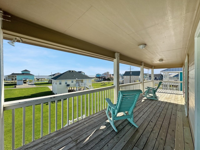 wooden terrace with a lawn