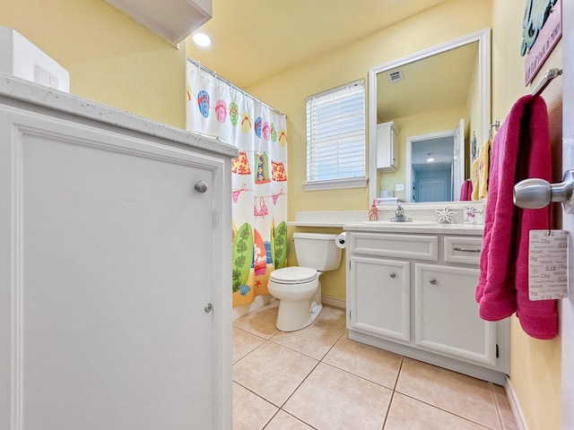 bathroom with toilet, tile patterned floors, vanity, and curtained shower