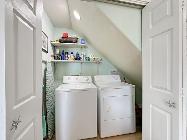 laundry area featuring light hardwood / wood-style flooring and washing machine and dryer