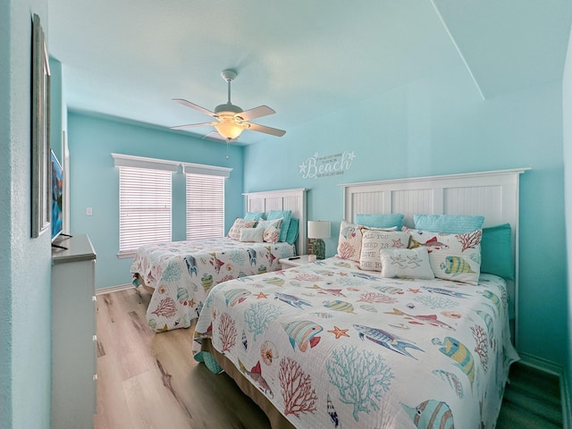 bedroom with ceiling fan and light wood-type flooring