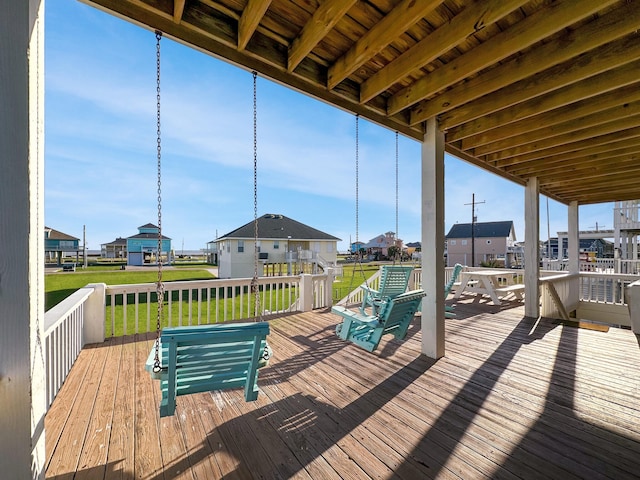 wooden terrace featuring a yard