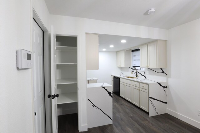 interior space with sink, dark hardwood / wood-style flooring, white cabinetry, and black dishwasher